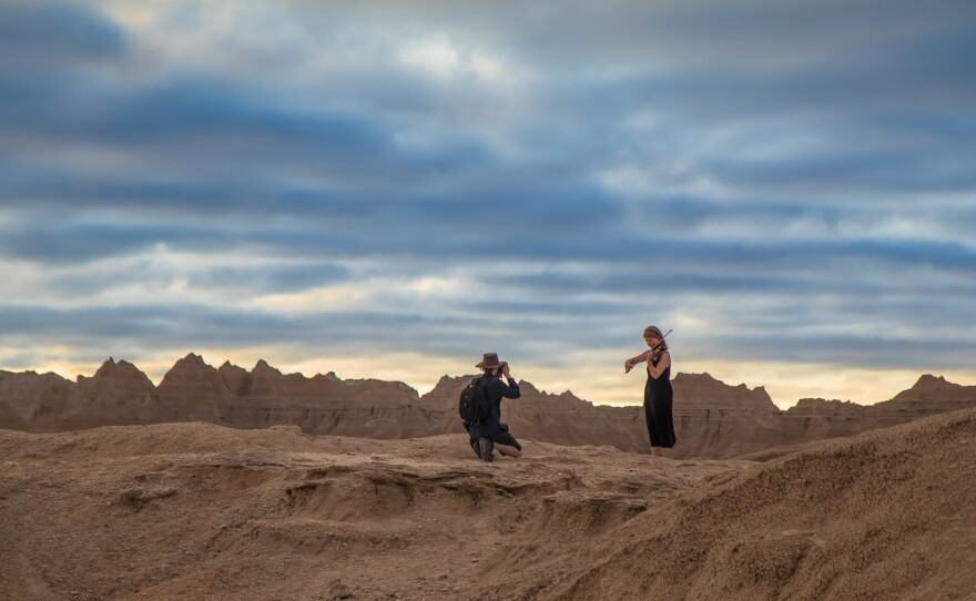 Two musicians standing at sunset in a national park