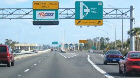 toll road.  This shows the two common methods of collection of tolls: toll booth (on right) and electronic toll collection (on left).