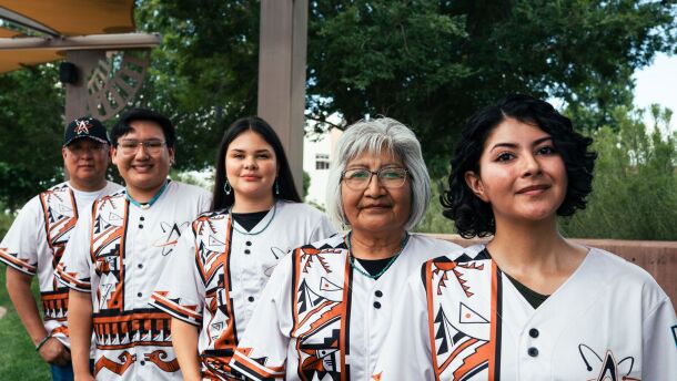 Marvis Vallo, Collin Magdalena, Paris Wise, Patsy Him, and Brittney Juancho model the special jerseys, which draw inspiration from San Ildefonso, Cochiti, and other Pueblo traditional styles. The Albuquerque Isotopes will wear the jerseys and caps on Saturday, Aug. 8.