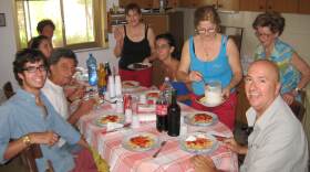 Family at a dinner table with plates of spaghetti 