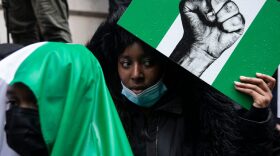 Protesters hold placards and signs calling for the end of police killings of the public in Nigeria, during a demonstration in London, England.