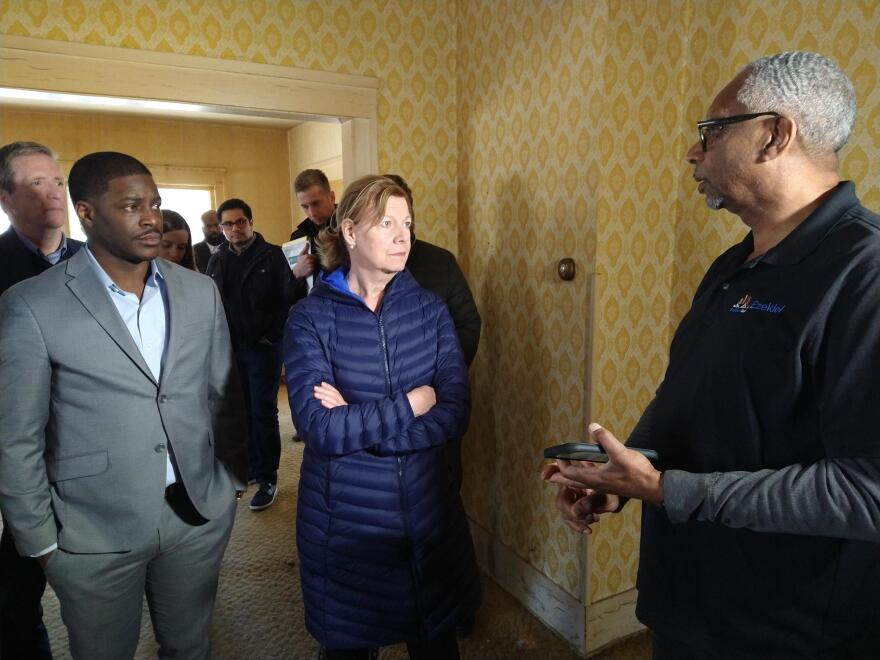 Milwaukee County Exec. David Crowley and U.S. Sen. Tammy Baldwin listen to Jim Gaillard (right) of Ezekiel Hope, during a tour Thursday.