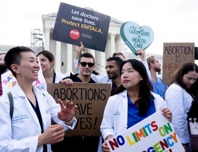Protestors stand in front of the Supreme Court while Idaho v. United States is argued.