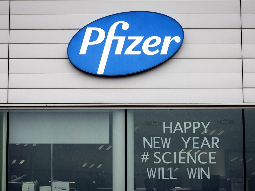 A sign appears in the window of an office at Pfizer Manufacturing in Puurs, Belgium, on Monday, the same day the European Medicines Agency authorized the use of the company's COVID-19 vaccine.