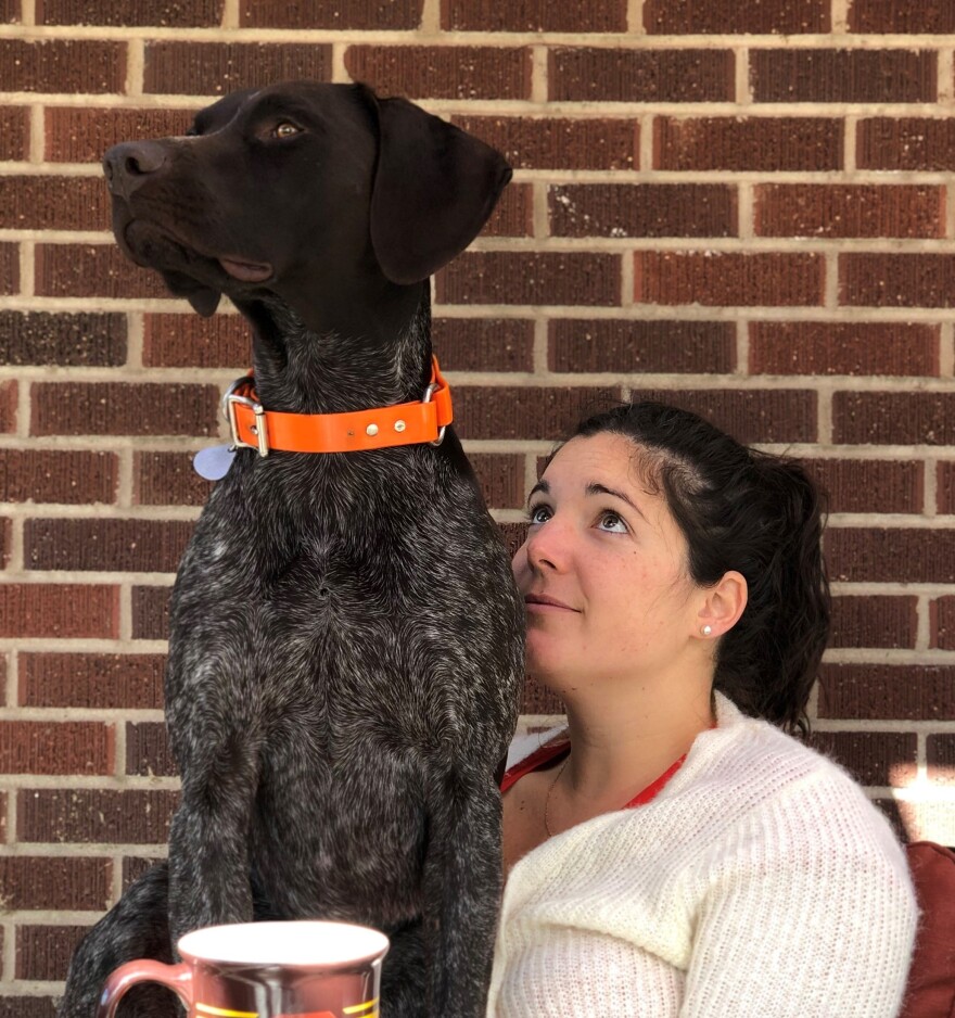 Annie Thompson, pictured with the couple's dog Roger. Will Thompson has not been able to accompany Annie to her prenatal doctor's visits, including one where they expected to learn their baby's gender.