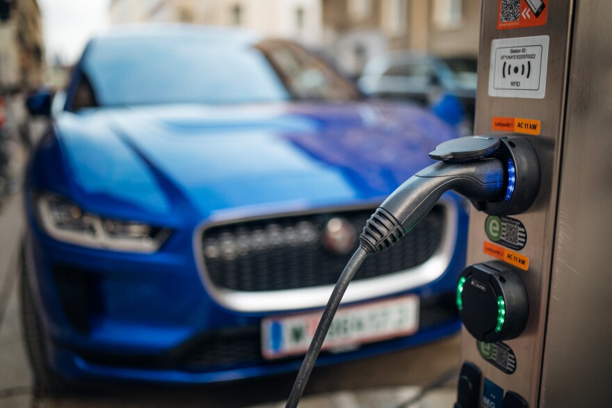 Close-up of an electric car charging station. Electric vehicle in a blurry background