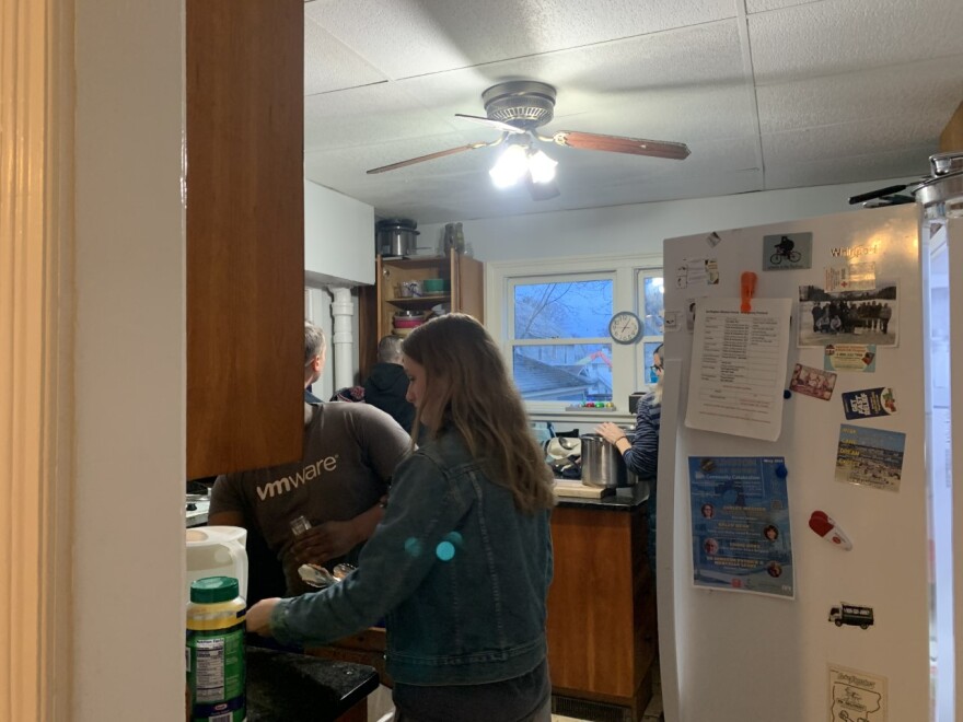 A picture of people doing dishes in a kitchen 