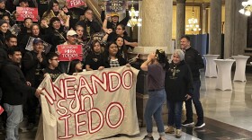 Supporters of an Indiana proposal that would allow immigrants living in the country illegally to obtain state-issued cards giving them permission to drive celebrate after the bill was endorsed by a state Senate committee on Tuesday, Feb. 7, 2023, inside the Indiana Statehouse in Indianapolis.