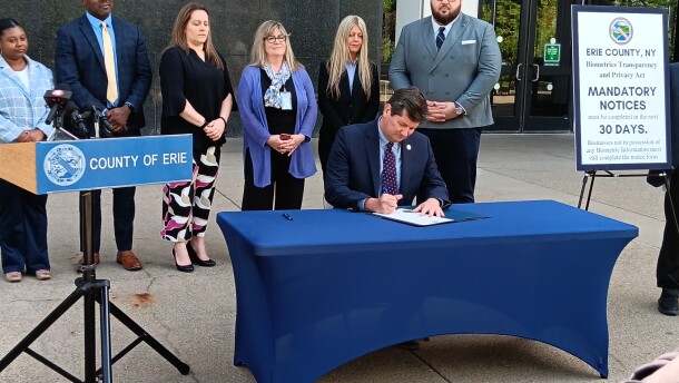 Erie County Executive Mark Poloncarz signs the county's new biometric privacy law into effect during a ceremony outside the Rath Building, Tuesday, May 26, 2026.