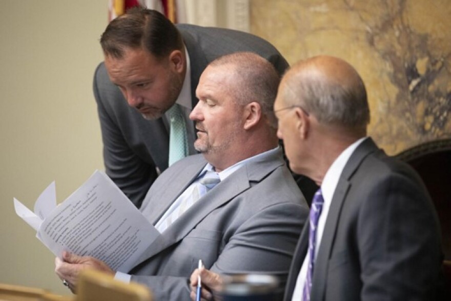 From left to right: Rep. David Muradian, Michael Moran and William Galvin go over their notes before the start of a joint rules conference committee meeting on May 15, 2025.