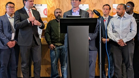 Gov. Bob Ferguson speaks about the financial fallout from tariffs at the Northwest Harvest food bank in Seattle.