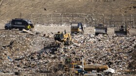 Trucks move trash in the Austin Community Landfill off Highway 290.