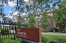 A large apartment building behind a sign reading "The Evanston."