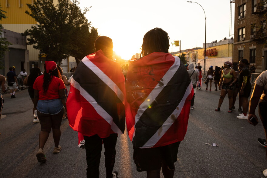 FILE - People with Trinidad and Tobago flag are seen during J'ouvert celebration, Sept. 4, 2023, in the Brooklyn borough of New York.