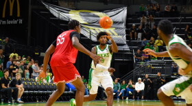 Oregon power forward Pharaoh Compton passes the ball over Seattle U center Halvine Dzellat in an exhibition game on Oct. 15, 2026 at Matthew Knight Arena in Eugene. Compton scored the most points for Oregon with 15 in the game.