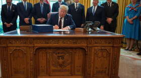 President Trump signs the CARES act, a $2 trillion rescue package to provide economic relief amid the coronavirus outbreak, at the Oval Office of the White House on Friday.Jim Watson/AFP via Getty Images