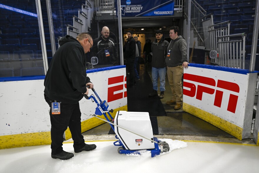 Jay Fruzia, Lead Ice Technician, works on the ice before the regional NCAA men’s hockey tournament game between Harvard and Ohio State on March 24, 2023, at Total Mortgage Arena, Bridgeport, Conn.