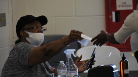 The poll worker seen from June isn't wearing their mask correctly, blunting its effectiveness at halting COVID-19's spread.