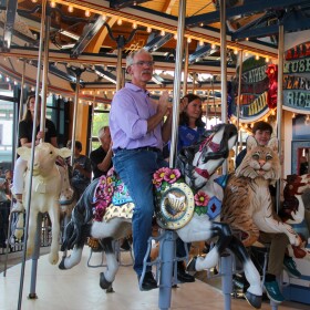 Todd Goings, president of Carousels and Carvings in Marion, sits on a horse during the inaugural ride of the new carousel at the Ohio State Fairgrounds.