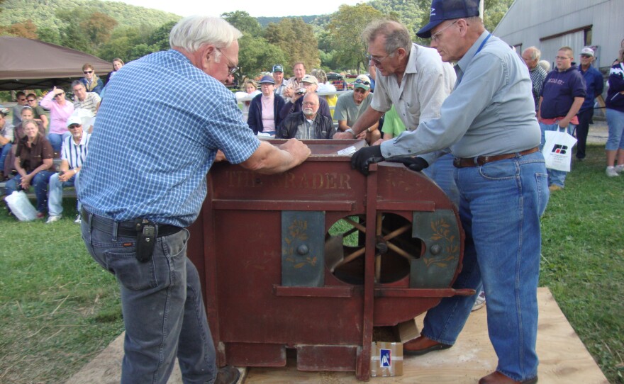 Volunteers demonstrate the operation of antique farm equipment at the Pasto Agricultural Museum. 