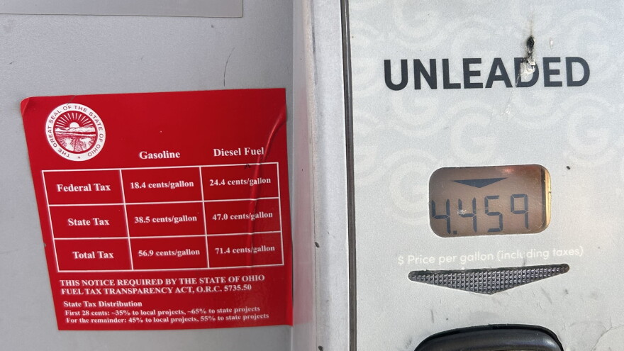 Signs on gas pumps at Giant Eagle on North High Street in Clintonville list federal and state gas taxes.