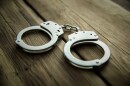 Handcuffs on wooden table