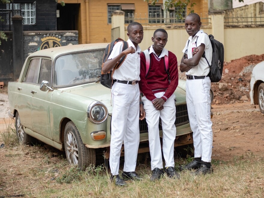 Kusemererwa Jonathan Henry, Joel Joseph (left and middle) and a friend pose for a photo on their way home from school. During the lockdown, they missed spending time in school together and would walk to visit each other.