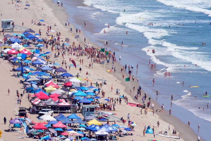 Beach goers watch during the the 46th Annual California Surf Lifesaving Championships on Will Rogers State Beach Friday, July 24, 2026, in the Pacific Palisades section of Los Angeles.