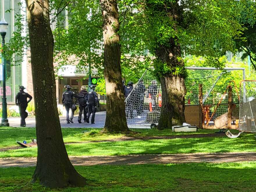 Portland police walk a suspected protester away from the Portland State University library on Thursday, May 2, 2024. Police converged on the PSU campus and library early in the morning to clear protesters who&#39;d occupied the library since Monday night.