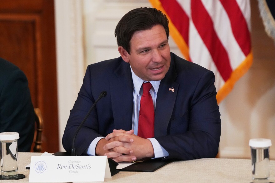 FILE - Florida Gov. Ron DeSantis is seen before a roundtable discussion on college sports in the East Room of the White House, Friday, March 6, 2026, in Washington.