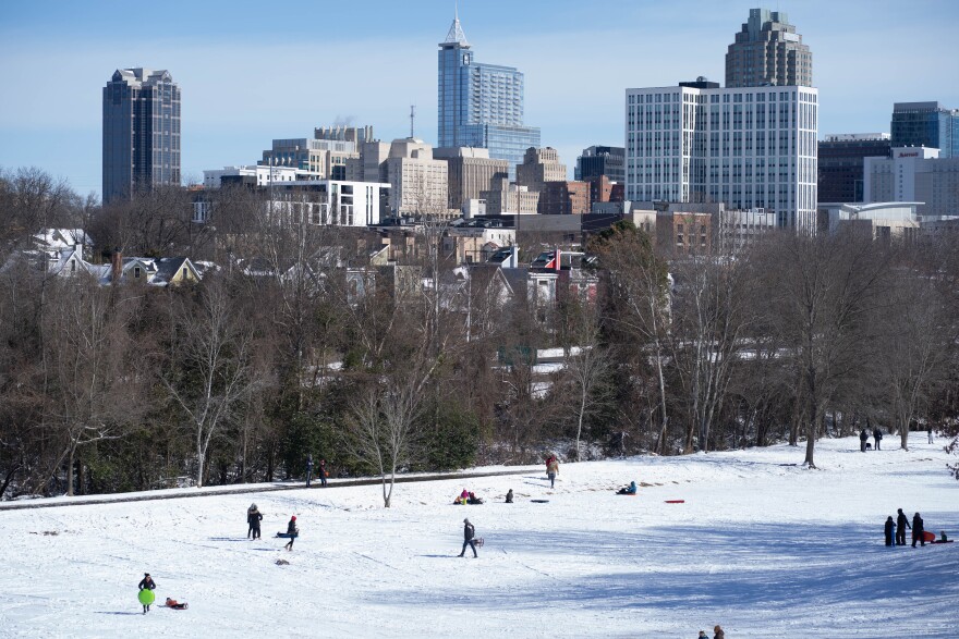 A snowfall that began late Saturday coated Raleigh, drawing eager sledders to Dix Park on Sunday to enjoy the winter weather.