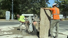 Construction workers use a large saw to dig up the 20-year-old concrete corridors.