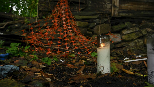 A candle burns in the backyard of an abandoned home where the remains of child were found in Connecticut. Under a new state law adopted in 2024, DCF must release certain information about children who die or nearly die due to abuse or neglect when requested.