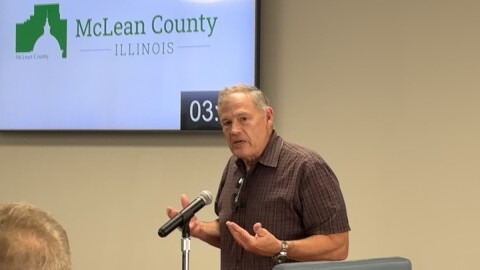 Man speaking in front of a microphone 