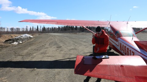 National Weather Service hydrologist Johnes Ostman radios out changes in river breakup to community members along the Kuskokwim from the Lower Kalskag airstrip on May 8, 2026.