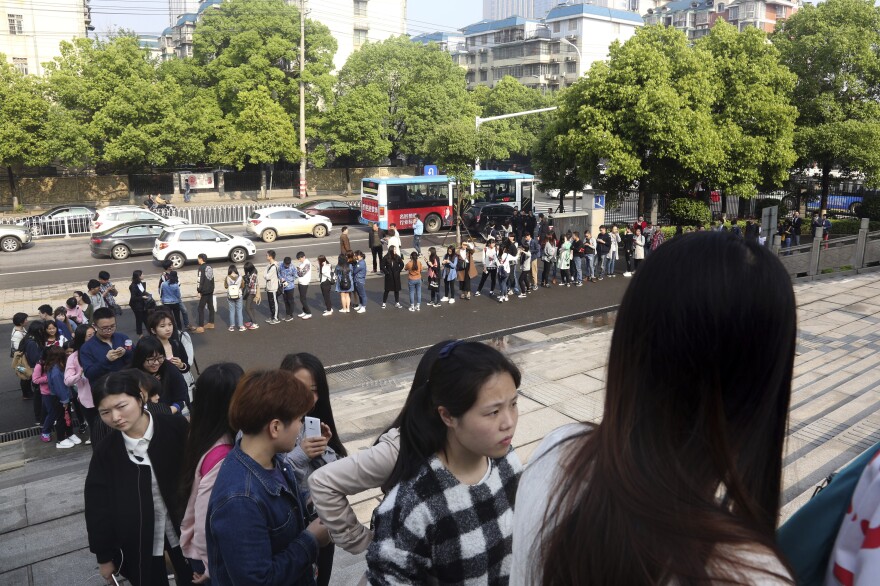 Supporters line up to attend the court session.