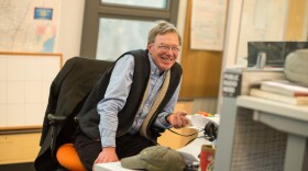 A person smiling in a chair