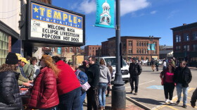People check out the NASA table in front of the Temple Theater in Houlton, Maine on Sunday, April 7, 2024.
