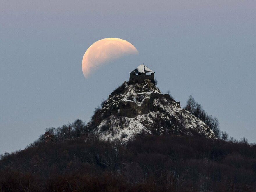 The moon is seen above the castle of Salgo, more than 60 miles northeast of Budapest, Hungary, during the eclipse early Monday.
