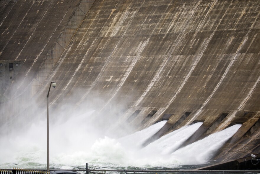 Water pours through the floodgates at Mansfield Dam along Lake Travis on Wednesday.