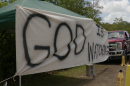 A banner advising "God Is Watching" greeted those who attended a prayer gathering Saturday at the entrance to the Everglades detention center off U.S. 41 near Ochopee.