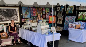 Ashley Miller (left) and Alyssa Wilcome display their work in one of the three Emerging Artist tents at the 2022 Ann Arbor Art Fair.