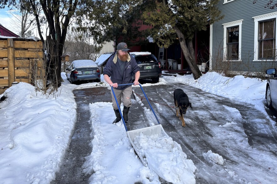 Harold Merrimont shovels heavy, wet snow on Wednesday in Plainfield, Vt.