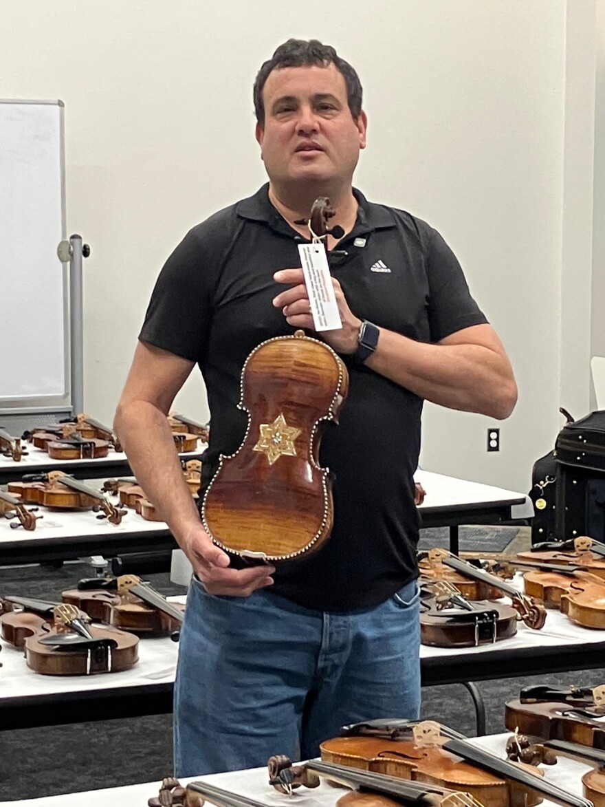 Weinstein shows a violin that had a Jewish Star of David carved on the back.
