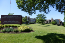 brick building on lush green hill with college sign in front: Hebrew Union College