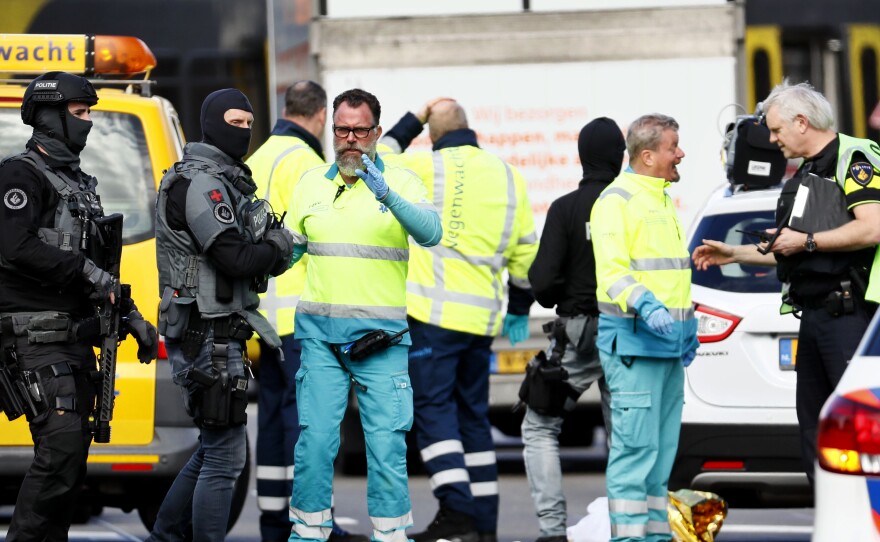 Police and emergency personnel stand at the intersection in Utrecht, Netherlands, where a shooting took place Monday.