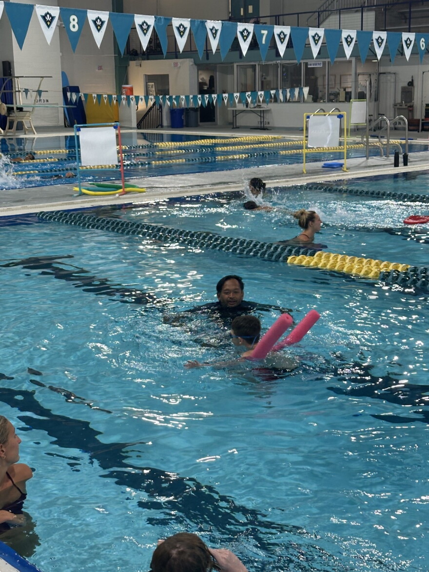 Bobby Guntoro is working with a swimmer one-on-one.