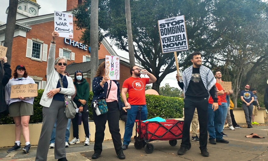 Central Floridians carry protest signs at Saturday's rally organized against Maduro’s capture and U.S. intervention in Venezuela.