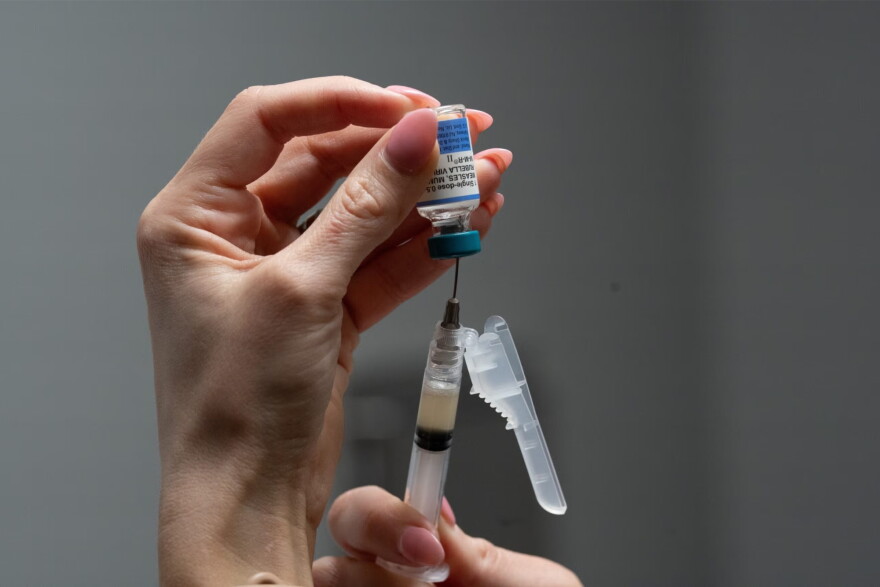 A nurse, prepares a combination measles, mumps and rubella vaccine for a patient at a pediatrics clinic in Easley, S.C. | Wisconsin Public Radio