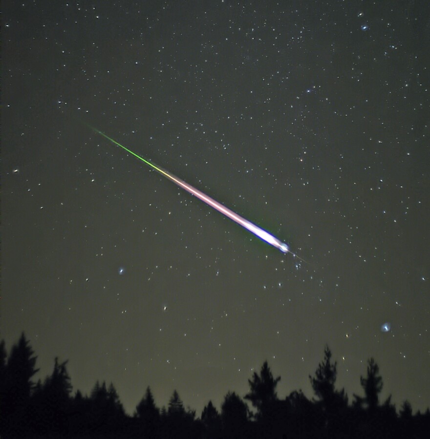 A meteor during the peak of the 2009 Leonid Meteor Shower. The photograph shows the meteor, afterglow, and wake as distinct components.